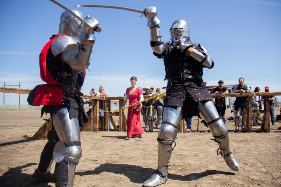 Armoured combatants clash during the High River Medieval Faire and Tournament on June 29.