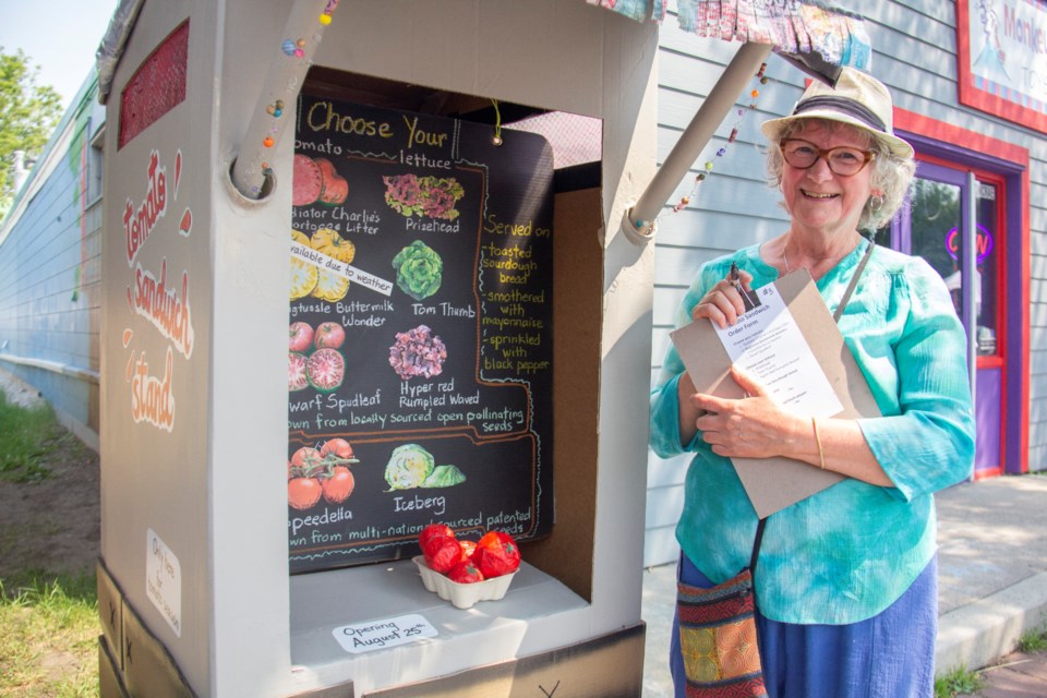 The Nooks & Crannies Festival brings 17 unique public art installations, like this mock tomato stand by Sharon Fortowsky (pictured), to downtown Okotoks from July 20 to Aug. 24.