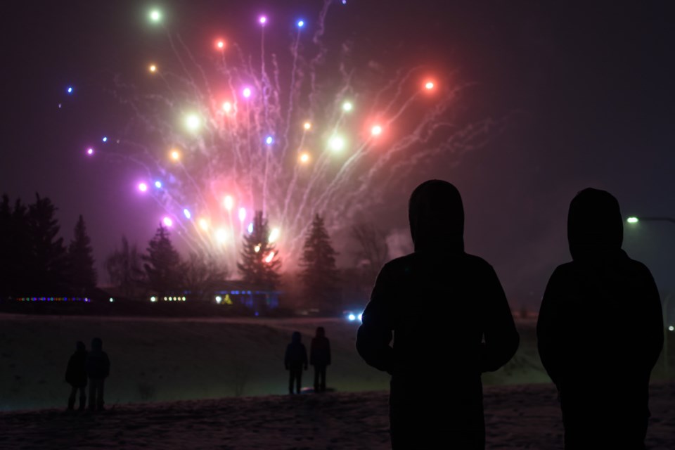 People gather near Northridge Drive to ring in the New Year with fireworks in Okotoks on Dec. 31. Fireworks launched from Lineham Park beginning at about 7 p.m. on New Years Eve.