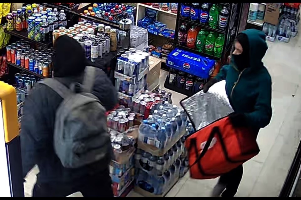 Surveillance footage shows two suspects in a break-in at an Elizabeth Street business in Okotoks on Jan. 14.