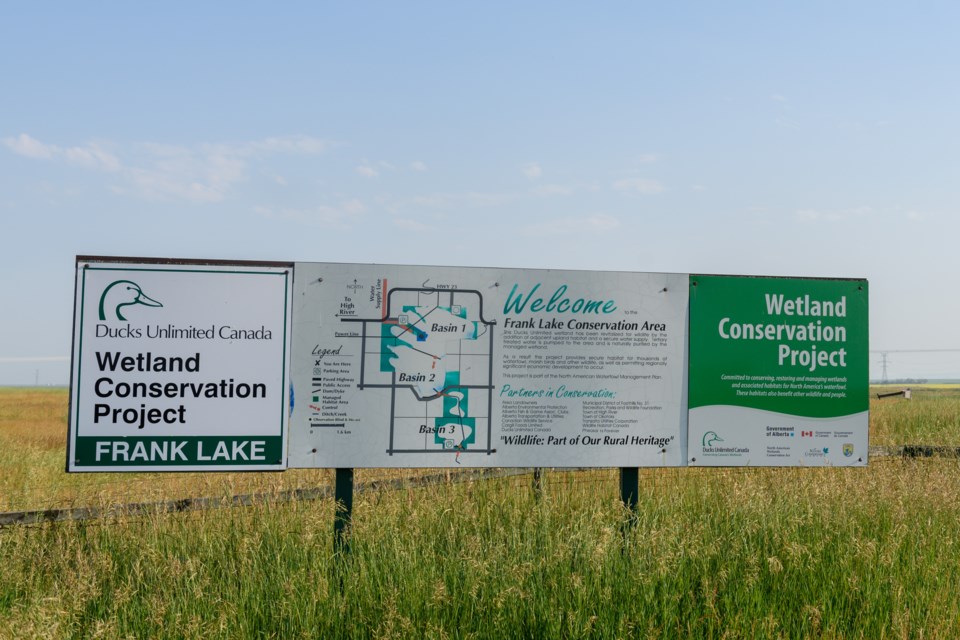 A sign with a map of the area greets visitors at the major entrance to Basin 1 at Frank Lake, off 530 Avenue in Foothills County. 