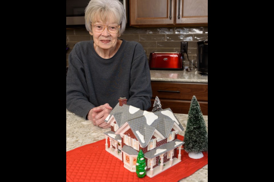 Anne Lalonde displays one the of earliest buildings in her collection at her Diamond Valley home.