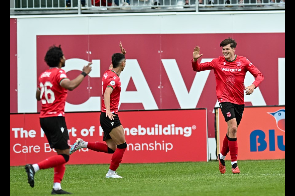 Cavalry FC's Tobias Warschewski  celebrates his goal with teammates midfielder Shamit Shome and attacker Lleyton Brooks during the 1-0 win over Forge FC on June 8 at Spruce Meadows' ATCO Field. (Mike Sturk/CFC Media)