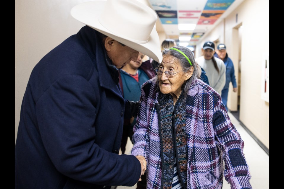 Recently re-elected Bearspaw Nation Chief Darcy Dixon greets elder Eileen Lefthand during the inauguration of the Bearspaw Nation Band Council on Jan. 10, 2019 at Chief Jacob Bearspaw Memorial School in Eden Valley. (Brent Calver/Western Wheel)