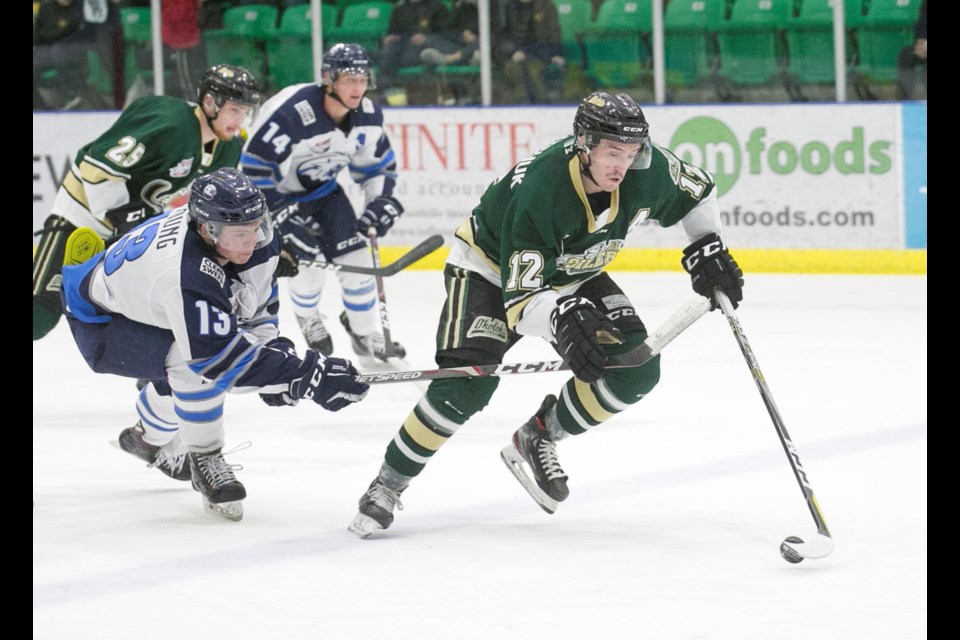 Okotoks Oilers forward Zane Kindrachuk evades the stick check of Canmore Eagles forward Alex Young. Kindrachuk, Marc Pasemko and Jack Works have formed a dynamite top line for the Oilers this season.
(Remy Greer/Western Wheel)