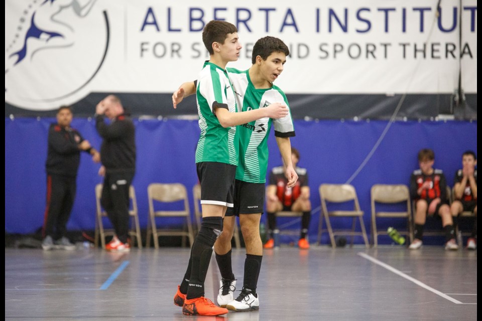 Lucas Oncea and David Hernandez celebrate the opening goal in the gold medal game of the U15 futsal Tier 2 division at the Anthem Communities Cup on Jan. 19 at Cavalry FC Regional Field House. Okotoks won by a 5-0 score.