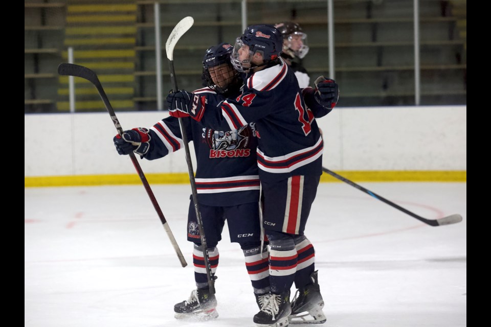 Carstar Okotoks Bisons forward Seamus Garagan celebrates his first period goal with linemate Owen McFarlane in the 5-1 win over the Medicine Hat Cubs on Nov. 8 at the Murray Arena.