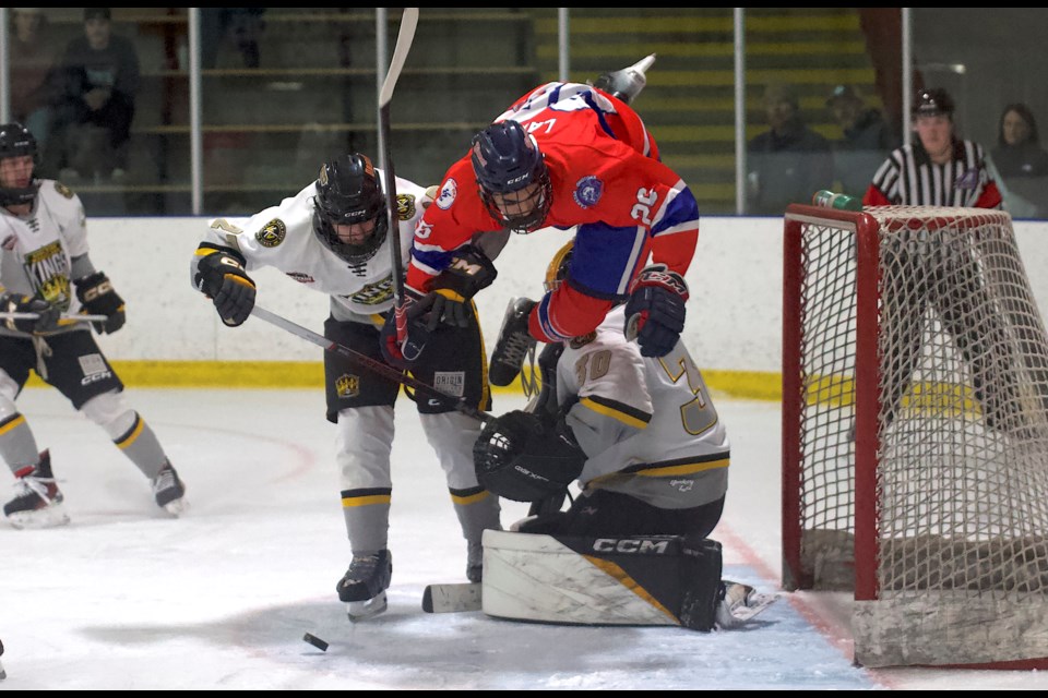 Carstar Okotoks Bisons defenceman Kegan Law flies through the air to avoid a collision with Agra Risk Wheatland Kings goalie Derrick Ford during Okotoks’ 5-4 win on Jan. 31 at the Murray Arena.