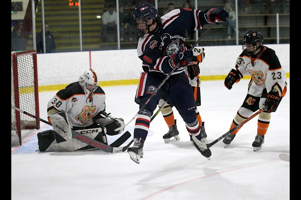 Carstar Okotoks Bisons forward Jady Shigehiro gets airborn for a deflection in front of goal versus the Coadale Copperheads on Feb. 2 at the Murray Arena. Okotoks clinched first place in the South Division with the 4-1 victory. 