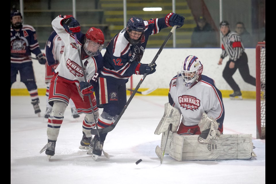 Carstar Okotoks Bisons forward Easton Dean battles with Cannex Cochrane Generals blueliner Zach Wilkins during Game 1 of the HJHL South Semifinal series on Feb. 21 at the Murray Arena. Okotoks won by a 3-2 score. 