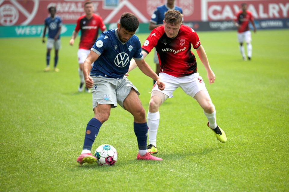 Cavalry FC attacker Gareth Smith-Doyle, right, battles with HFX Wanderers left back Wesley Timóteo during the Canadian Premier League match on July 15 at Spruce Meadows’ ATCO Field. The Cavs won 1-0 on Wanderers own goal in stoppage time. 