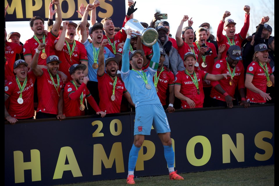 Cavalry FC captain Marco Carducci lifts the North Star Cup in front of his teammates after the team defeated Forge FC 2-1 in the Canadian Premier League Final on Nov. 9 at Spruce Meadows’ ATCO Field.