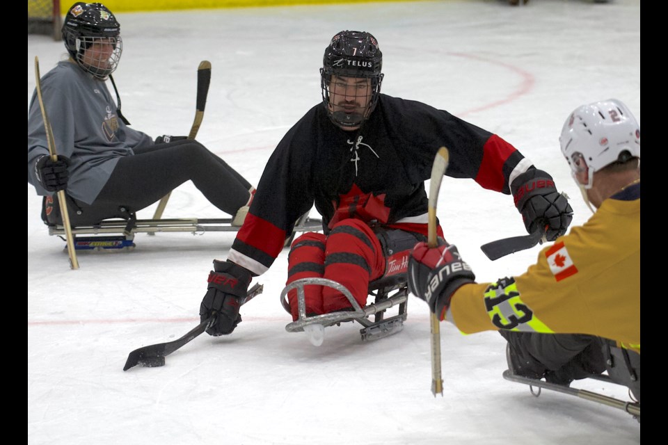 The High River Fire Dept. and the Town of Okotoks' 'Governerds' compete during the second annual Cederstrand Foundation Sledge Hockey Tournament on Nov. 30 at the Viking Rentals Centre. 