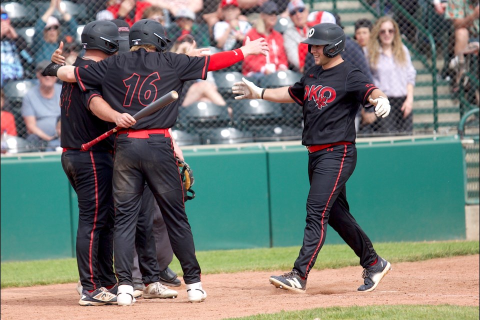 Okotoks Dawgs outfield Tucker Zdunich celebrates his three-run home run with teammates Nash Crowell, Ricky Sanchez and Brendan Luther during the 12-4 win over the Lethbridge Bulls on June 9 at Seaman Stadium.