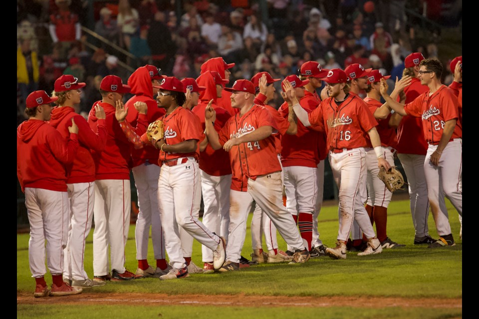 The Okotoks Dawgs celebrate the 10-4 win over the Swift Current 57's in the annual Canada Day Game at Seaman Stadium on July 1. 