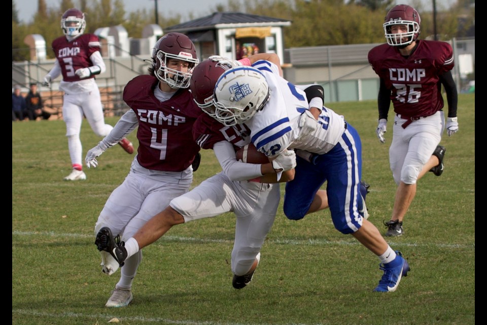 Foothills Falcons Asher Nelson and Darrian Campbell make a tackle in the secondary during the 17-7 win over the Catholic Central Cougars on Oct. 4 in Okotoks. Nelson and Campbell combined for three interceptions to key the defensive effort.