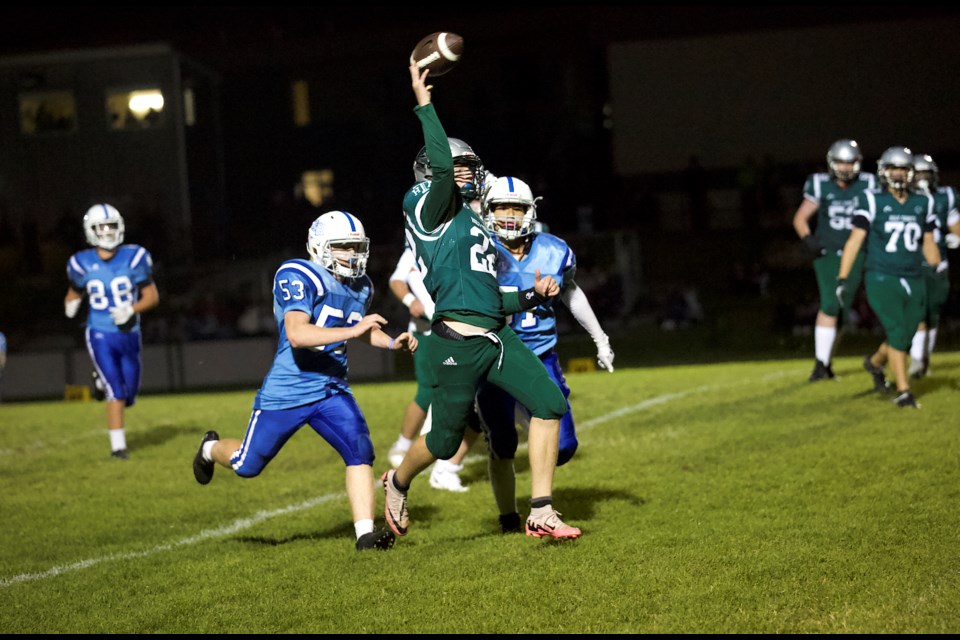 Holy Trinity Academy Knights quarterback Brenden Petersen scrambles out of the pocket before connecting with Alex Horsman for the final touchdown in the 45-13 win over the Catholic Central Cougars on Sept. 13 in Okotoks. 