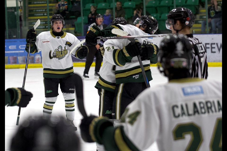 Okotoks Oilers forward Spencer Rheaume is mobbed by teammates after scoring the overtime winner over the West Kelowna Warriors in the 3-2 triumph in BCHL action on Nov. 9 at the Viking Rentals Centre.