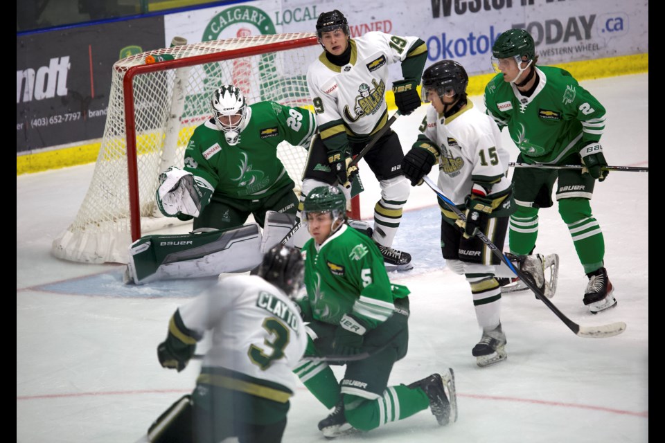 Okotoks Oilers forward Spencer Rheaume provides a screen on Cranbrook Bucks goaltender Jaden Cholette with defenceman Cyle Clayton getting off a shot during BCHL pre-season action at the Viking Rentals Centre on Sept. 14. Okotoks opens its regular season at home on Sept. 20 versus the Brooks Bandits. 