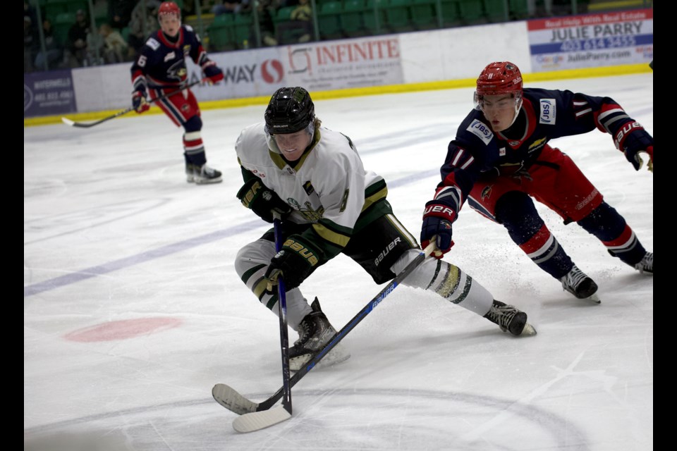 Okotoks Oilers forward Joey Meredith wins a neutral zone puck battle during the BCHL regular season opener against the Brooks Bandits on Sept. 20 at the Viking Rentals Centre. 