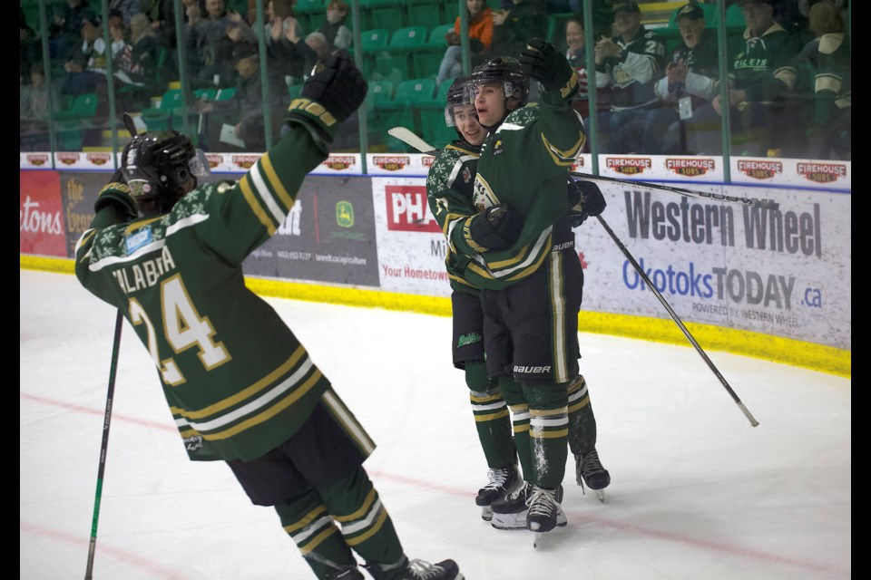 Okotoks Oilers forward Spencer Rheaume celebrates his game winning goal late in the third period with teammates Kade Duell and Luke Calabria during the 5-4 win over the Spruce Grove Saints on Dec. 14 at Viking Rentals Centre.