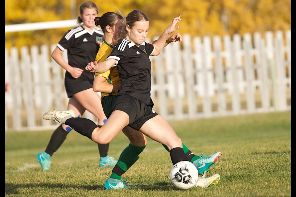 Lainey Fischer fires a shot from distance during the Holy Trinity Academy Knights’ 1-0 win over the Canmore Wolverines in the Foothills Athletic Council girls soccer clash on Oct. 15 at Bill Robertson Park in Okotoks.