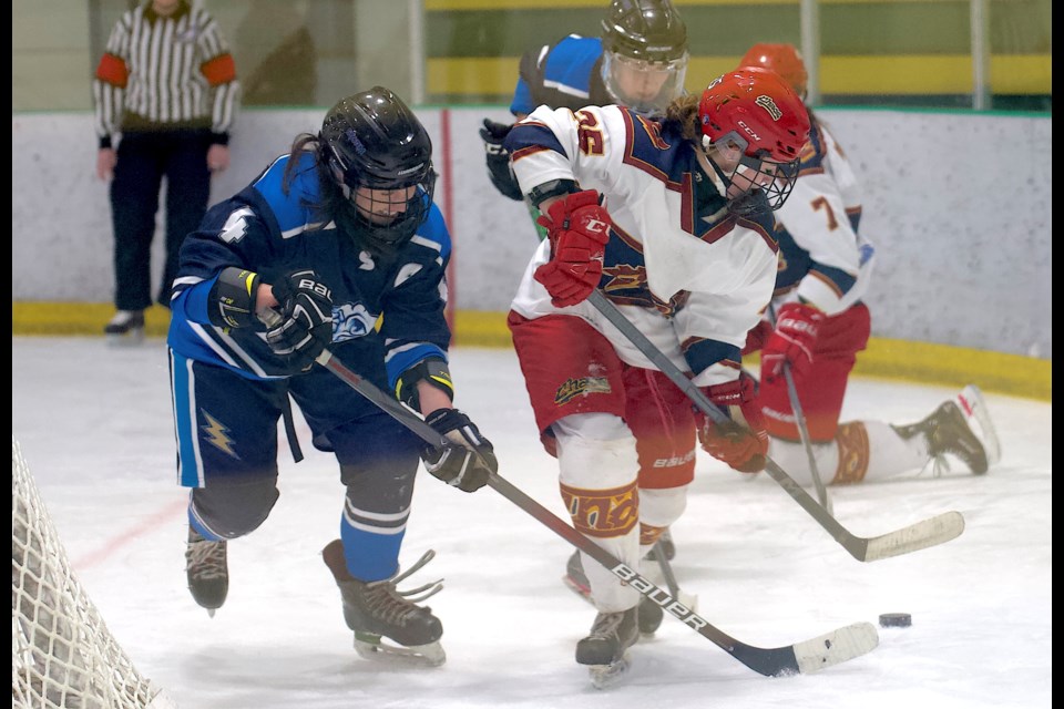 Cochrane Chaos forward Lacey Bullee battles behind the net with Khloe Bedore of the Foothills Storm during the Chaos' 7-2 win in Alberta Junior Female Hockey League action on Nov. 9 at the Viking Rentals Centre in Okotoks. Foothills won the following day in Cochrane by a 3-2 score to snap the Chaos’ 12-game winning streak to start the season.