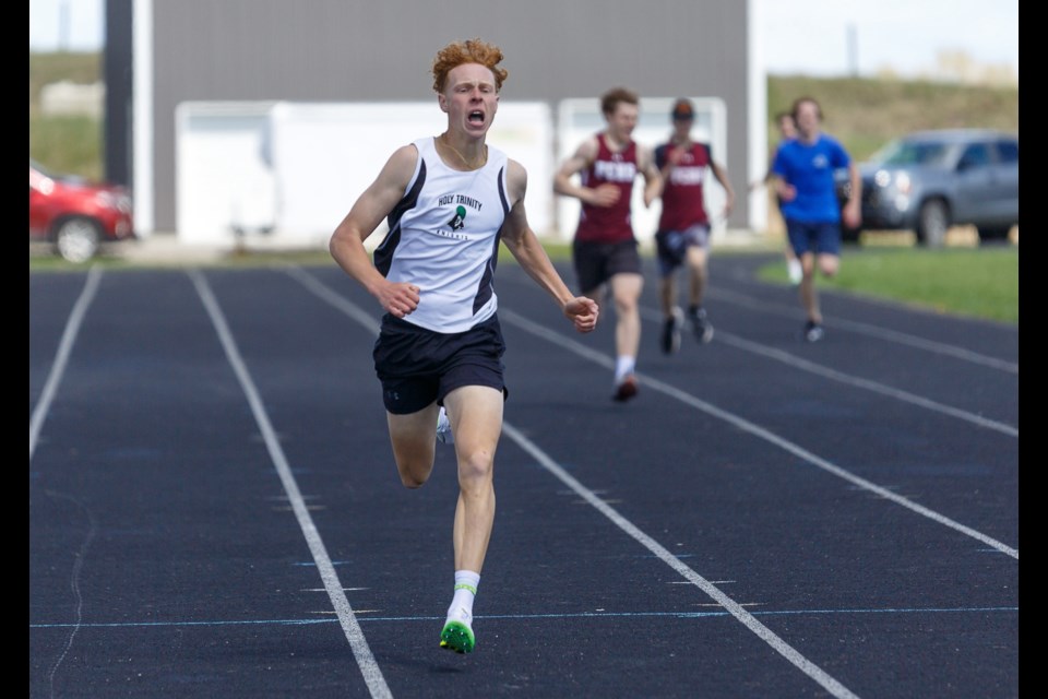 Holy Trinity Academy Knight Peter Wonderham speeds into the finish line during track and field divisionals in Okotoks. Wonderham, a Grade 12 student, finished first in the senior boys 400m and 800m events at the South Central Zone Track and Field Championships on May 22 at Calgary’s Foothills Athletics Park.