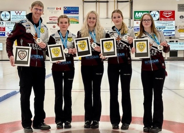 Team Yurko poses after winning the Alberta Optimist U18 Girls Provincial Curling Championship on Jan. 6 in Lacombe. From left: coach Glenn Ector, lead Kendra Koch, second Abigail Mielke, third Reese Morison and skip Alena Yurko, from Okotoks. 