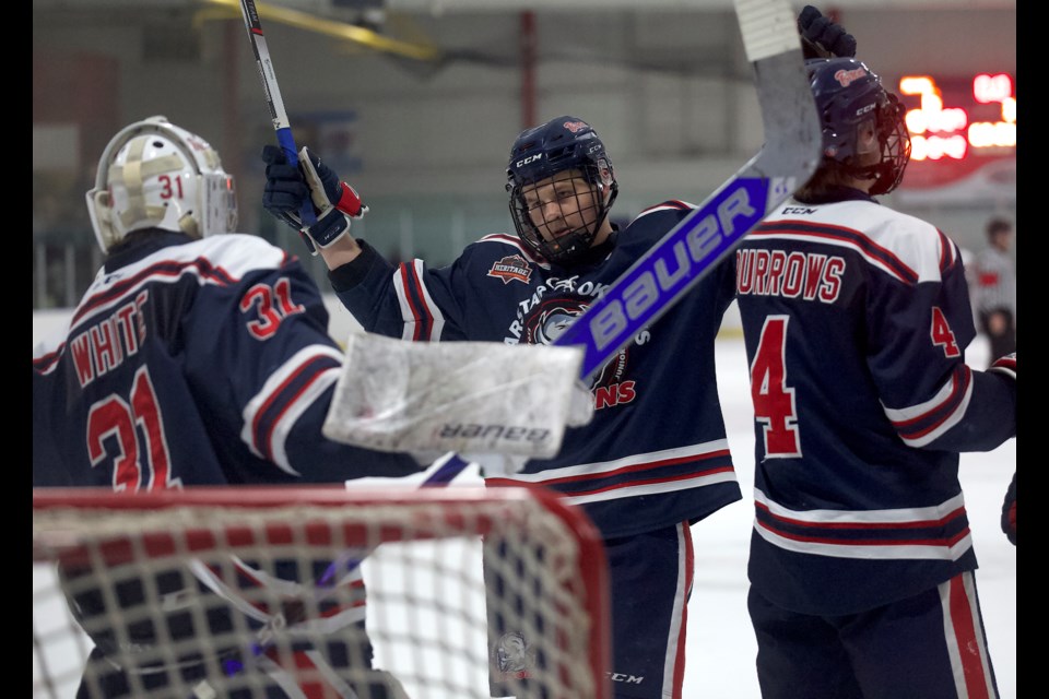 Carstar Okotoks Bisons defenceman Kaelan Bodnarchuk celebrates the 6-2 victory with goalie Connor White following the Heritage Junior Hockey League clash versus the Three Hills Thrashers on Jan. 4 at the Murray Arena.