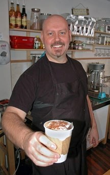 Hendrik van Wyk, owner of Figaro&#8217;s Gelateria, serves up a piping hot mochachino last week. While hot drinks have been popular at the Okotoks business, he said the cold