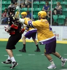 Coquitlam&#8217;s Kevin Schoemaker, right, gives Whitby captain John Lafontaine a cross-check during the Warriors 5-4 win on Aug. 27 at Centennial Arena.