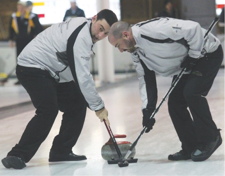 Team Libbus second Brad McInnis, left, and third Mike Libbus, right, sweep during the A final of the southern playdowns, Jan. 21 at the Inglewood Curling Club in Calgary. The 