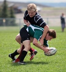 Holy Trinity Academy Knight Stephen Ference is tackled by Foothills Falcon Robbie McLean during the South Central Zone Tier I championship game May 30 in Calgary.