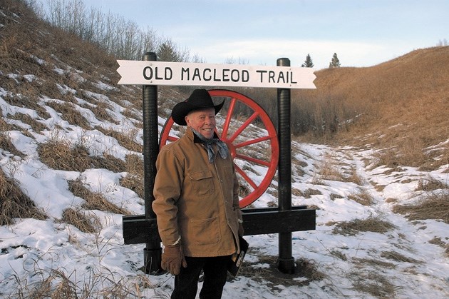 Foothills historian Bill Dunn looks over the route of the Old Macleod Trail in Okotoks after unveiling a wagon wheel marker in town on Dec. 8. It&#8217; s one of 17 lining