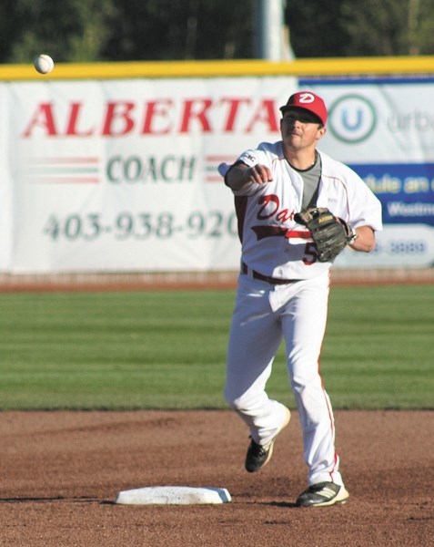 Okotoks Dawgs second baseman Rylan Chin throws to first base during a game last summer at Seaman Stadium. The veteran Dawg was named the team&#8217; s 2012 True Grit Award