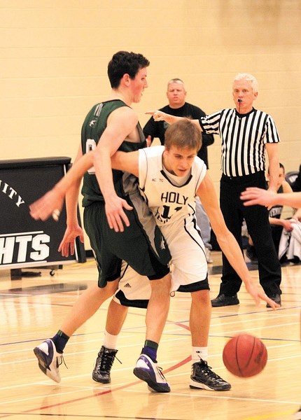 Holy Trinity Academy Knight Matt Vant Erve tries to work his way around a Centennial Coyote on Jan. 30 in Okotoks