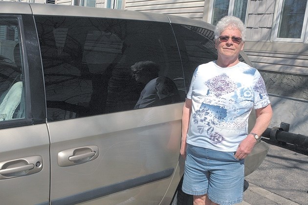 Okotoks resident Judy Yorke shows where someone keyed the side of her minivan sometime overnight on May 3 &#8211; 4. Hers was one of 10 vehicles behind Sheep River House that 