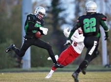 Holy Trinity Academy Knights defensive back Connor Brogden reaches out for a first-half interception versus the Raymond Comets on Oct. 3 at Knights field. The Comets soared