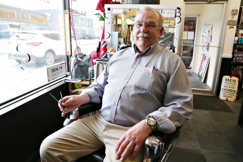 Doug Berg readies his scissors on his last day of work on April 24 at Image Hair Design after 28 years of trimming the hair of Okotoks residents.