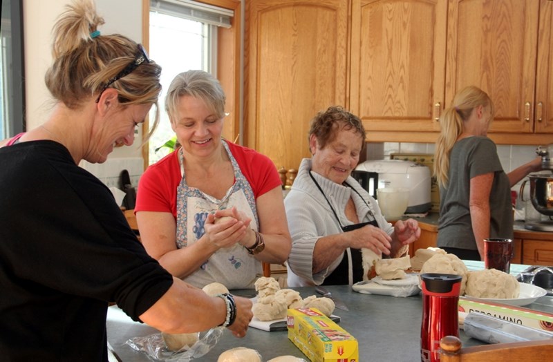 Tracey Leduc, left, wraps portions of pastry as Karna Wolfe, centre, and Eva Ingram weigh and divide the dough during a work bee on Sept. 19. Nine ladies gathered to prepare