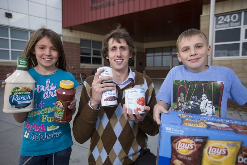 Grade 6 teacher Graham Campbell and his students Nyah Ulmer, left, and James Jewer show off some chow at Westmount School on Thursday, Nov. 5, 2015.