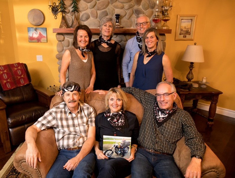 Joan Fiddler (front, centre) holds a picture of her husband Jim while surrounded by friends. Jim died in the Foothills Country Hospice on Oct. 12. Back row: Verna