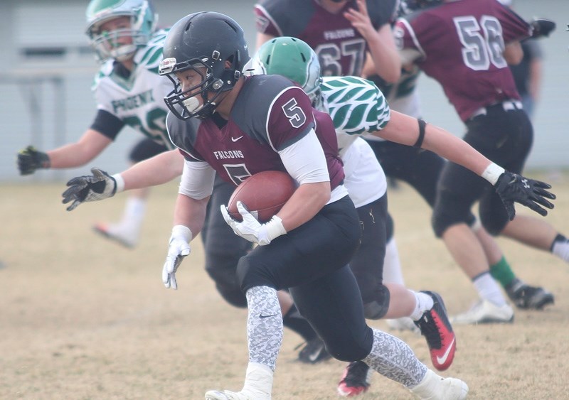 Foothills Falcon Jude Oh goes for a big run during the team&#8217;s 38-7 triumph over the Springbank Phoenix in the regional qualifier, Nov. 5 at Falcons field.