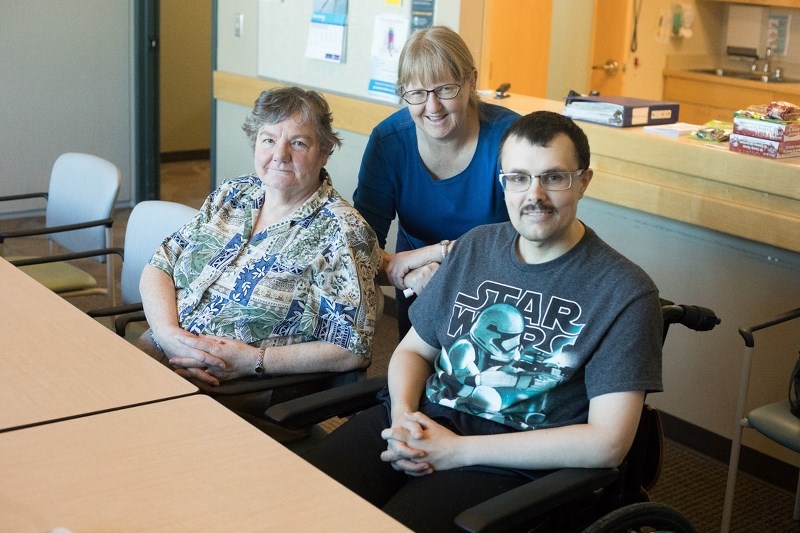 LPN Amy Armstrong of the Adult Day Support Program, is joined by patrons Edie Weisbeck, left, and Reghan Fitzgerald on Dec. 20.