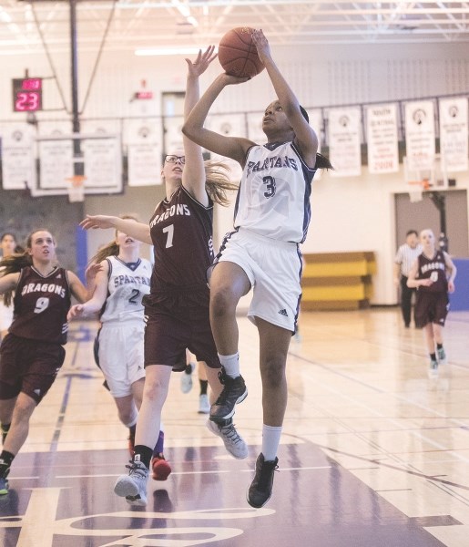 Strathcona-Tweedsmuir Spartans Emy Udoh drives the lane versus the Didsbury Dragons at the Spartans Invitational.