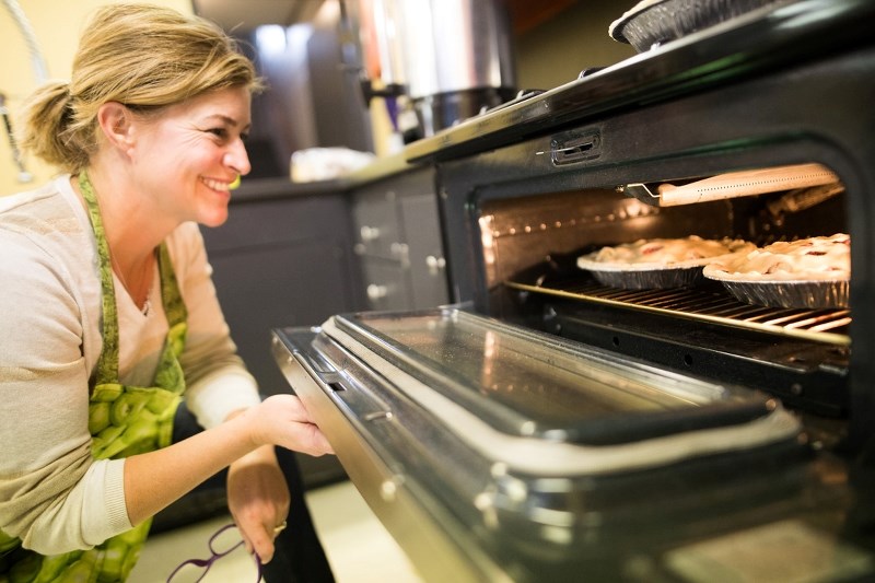 Event co-organizer Diana Froc checks on some pies baking for the annual Davisburg Turkey Supper on Oct. 1.