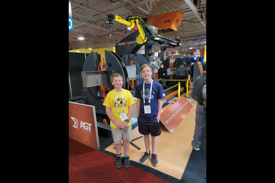 Grade 4 Notre Dame Catholic School student Marcus Milliard, left, and Grade 8 Monsignor Lee Catholic School student Zach Emons were among the PF Robotics team's representatives at the FABTECH trade show in Toronto recently.