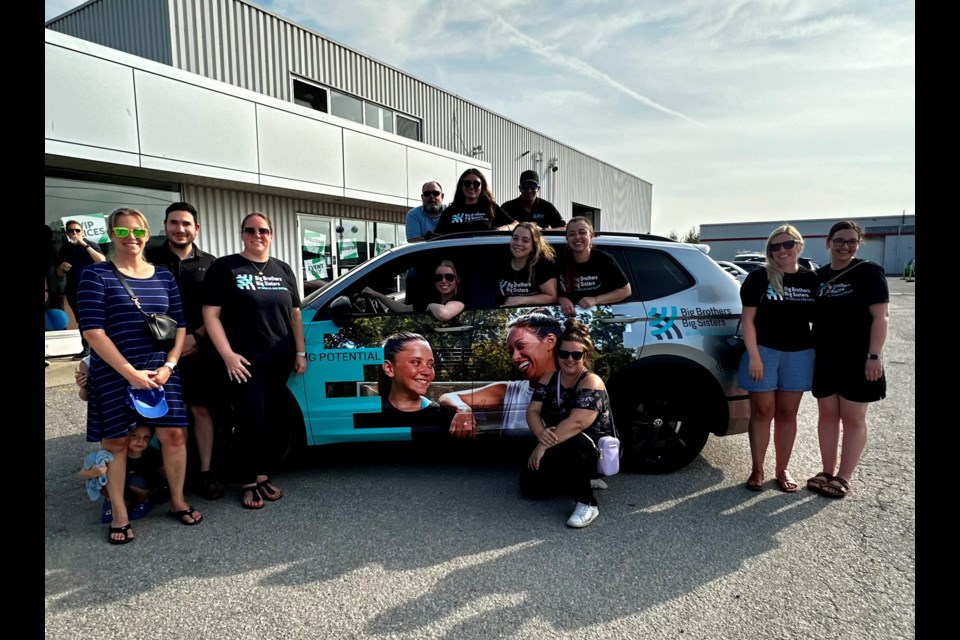 Members of Orillia Volkswagen and Big Brothers Big Sisters gathered for a celebratory barbecue at the dealership Thursday afternoon.