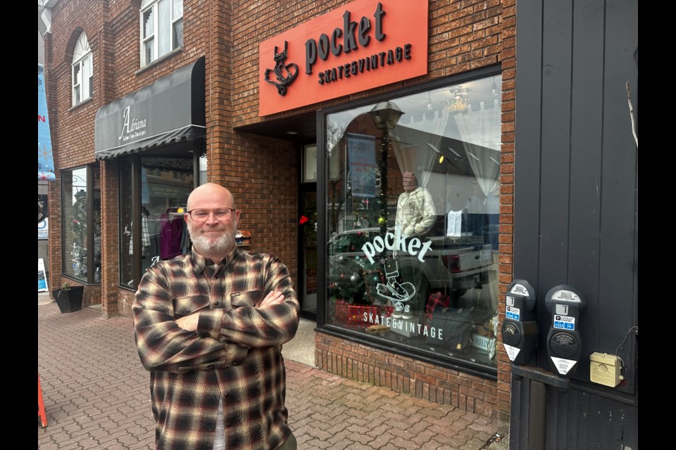 Mark Watson, owner of Pocket Skate & Vintage, is among a group of downtown merchants calling for the free holiday parking program to come back. 